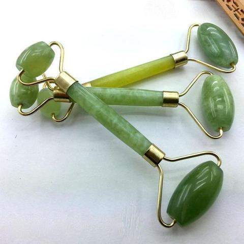 Green and pink jade facial massage roller made from natural stone