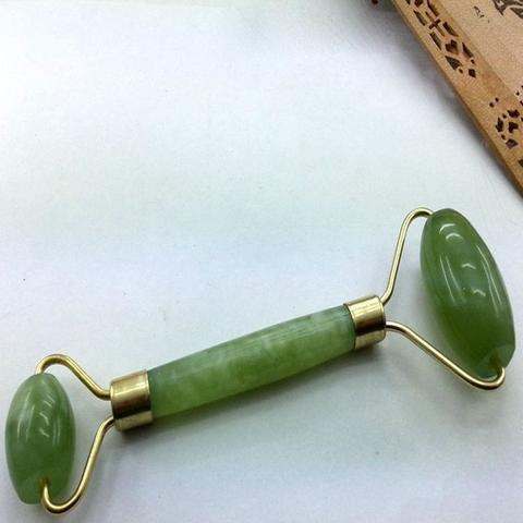 Green and pink jade facial massage roller made from natural stone