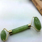 Green and pink jade facial massage roller made from natural stone