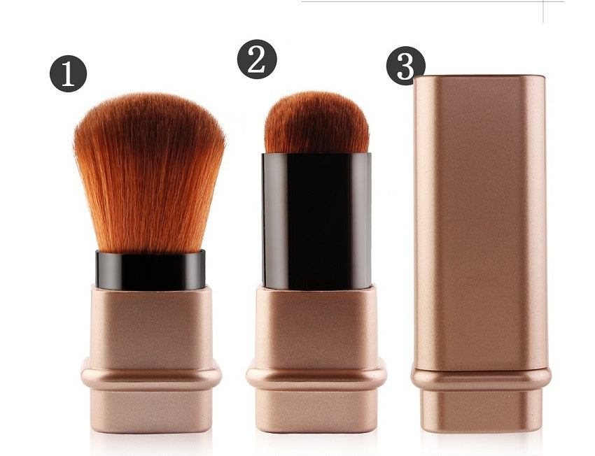 Portable single makeup brush in square gold or square silver with soft fiber bristles