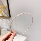 White pearl headband for women with imitation pearls on a metal band