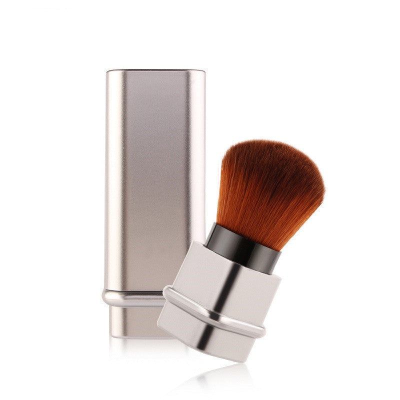 Portable single makeup brush in square gold or square silver with soft fiber bristles