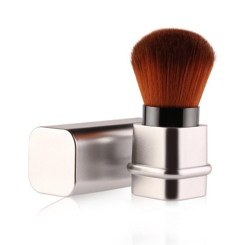 Portable single makeup brush in square gold or square silver with soft fiber bristles