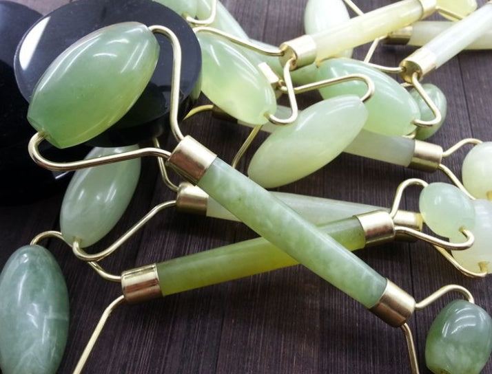 Green and pink jade facial massage roller made from natural stone