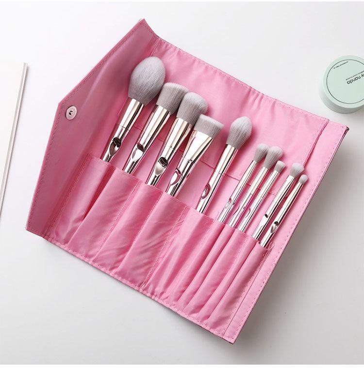 Pink makeup brush set with soft bristles and pink clutch bag