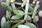 Green and pink jade facial massage roller made from natural stone