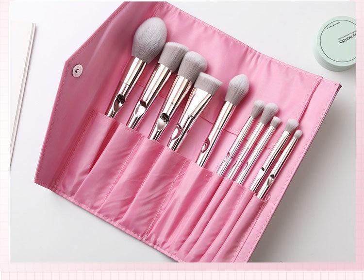 Pink makeup brush set with soft bristles and pink clutch bag