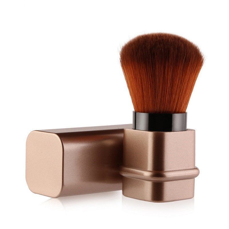 Portable single makeup brush in square gold or square silver with soft fiber bristles