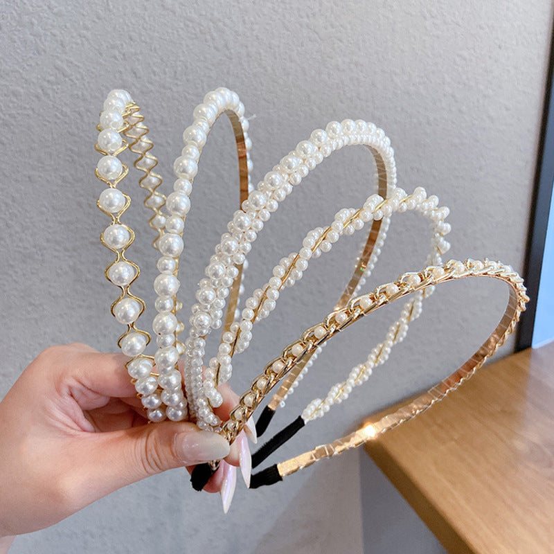White pearl headband for women with imitation pearls on a metal band