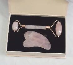 Green and pink jade facial massage roller made from natural stone