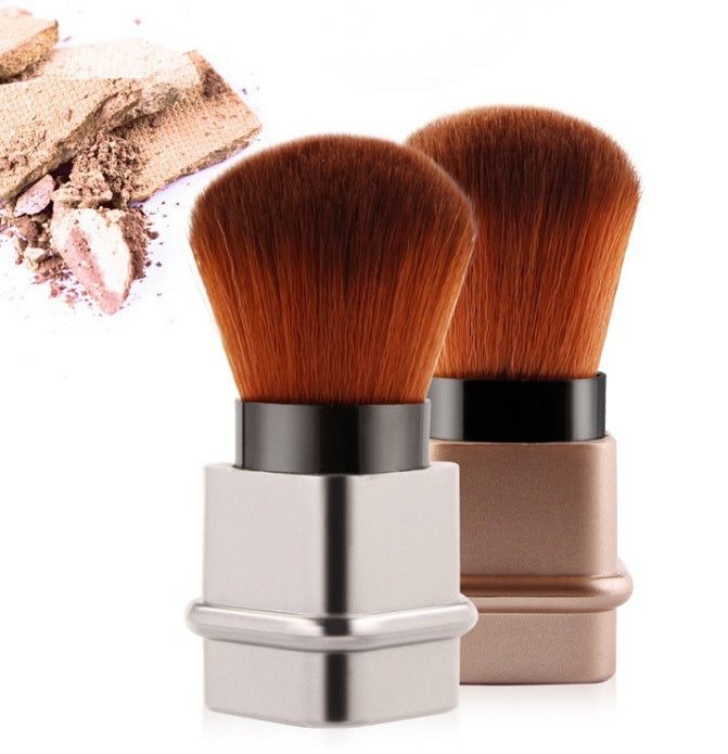 Portable single makeup brush in square gold or square silver with soft fiber bristles