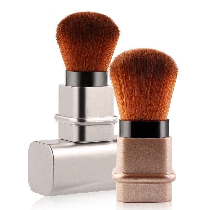 Portable single makeup brush in square gold or square silver with soft fiber bristles