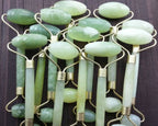 Green and pink jade facial massage roller made from natural stone