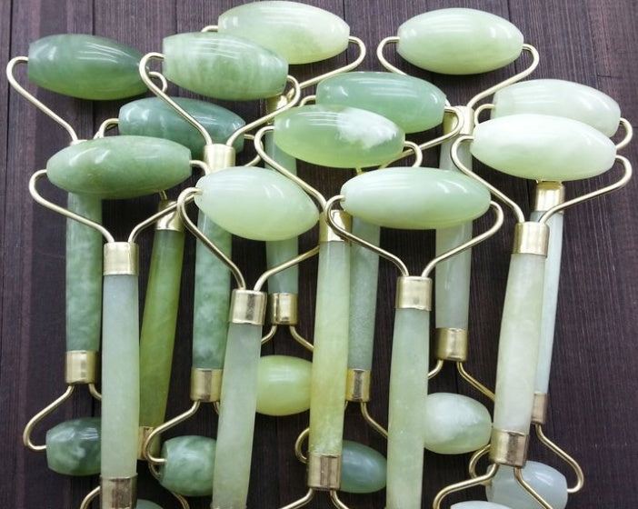 Green and pink jade facial massage roller made from natural stone