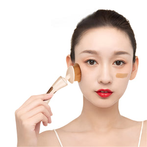 Woman applying makeup with a brush on a white background