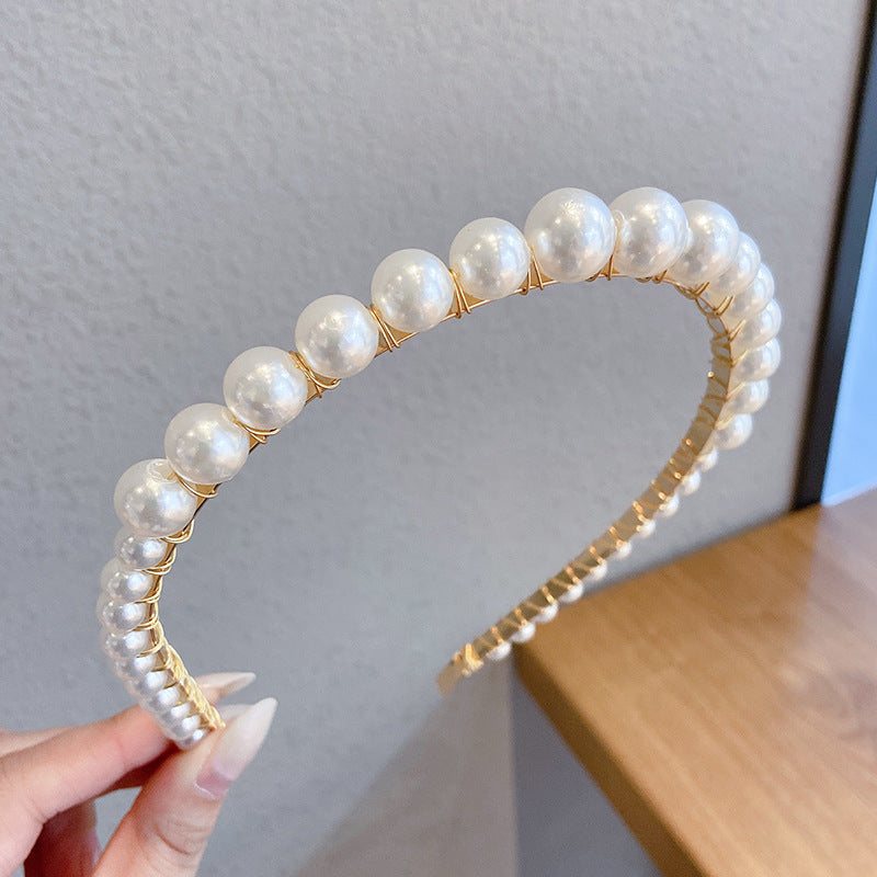 White pearl headband for women with imitation pearls on a metal band